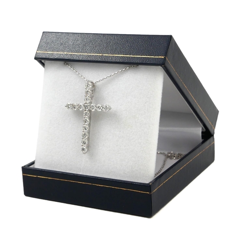 20 - AN 18CT WHITE GOLD CROSS, SET WITH ROUND BRILLIANT CUT DIAMONDS on an 18ct white gold chain.  
(Diam... 