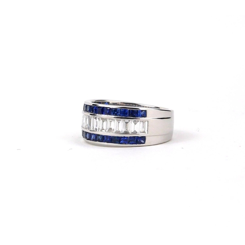 56 - AN 18CT WHITE GOLD ETERNITY RING SET WITH A ROW OF BAGUETTE CUT DIAMONDS flanked by 2 rows of prince... 