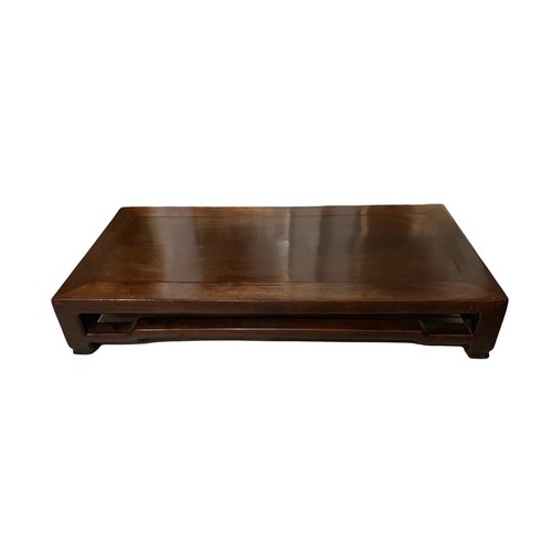 84 - A 19TH CENTURY CHINESE HARDWOOD KANG TABLE
The single panel top set within a rectangular frame above... 