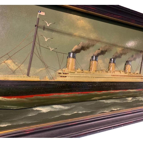 115 - A 20TH CENTURY PAINTED AND CARVED WOOD DIORAMA, THE TITANIC
Held in an ebonised and parcel gilt fram... 