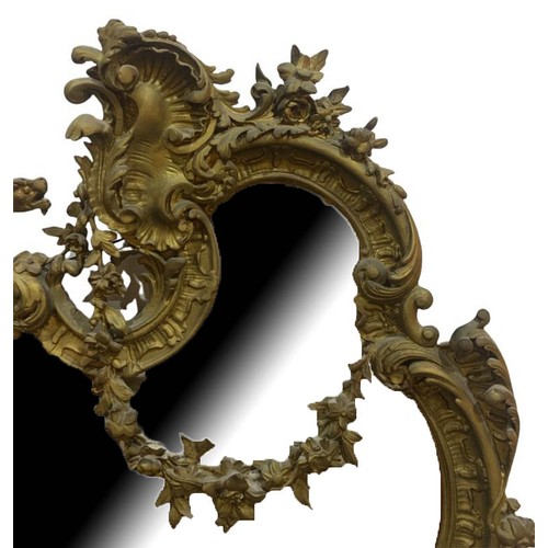 152 - A LARGE EARLY 19TH CENTURY GILTWOOD AND GESSO ROCOCO MIRROR
The cartouche form frame decorated with ... 