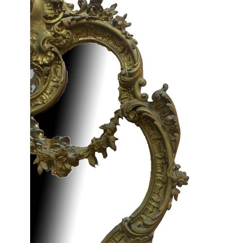 152 - A LARGE EARLY 19TH CENTURY GILTWOOD AND GESSO ROCOCO MIRROR
The cartouche form frame decorated with ... 