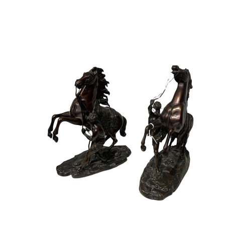 143 - AFTER COUSTOU, GUILLAUME, 1677 - 1746, A PAIR OF FRENCH PATINATED BRONZE GROUPS OF THE MARLY HORSES
... 