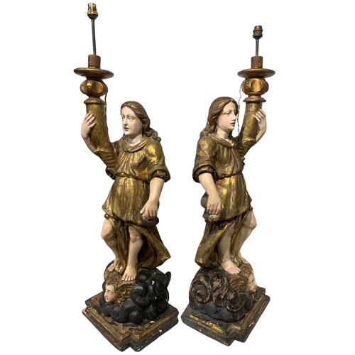 170 - A LARGE PAIR OF 17TH/18TH CENTURY ITALIAN CARVED GILTWOOD AND POLYCHROME STATUES
Depicting angels ho... 