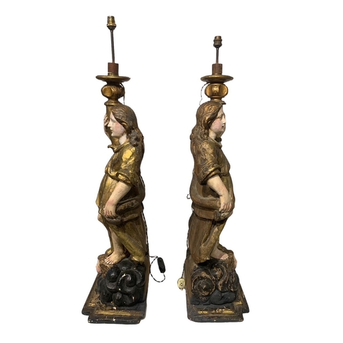 170 - A LARGE PAIR OF 17TH/18TH CENTURY ITALIAN CARVED GILTWOOD AND POLYCHROME STATUES
Depicting angels ho... 