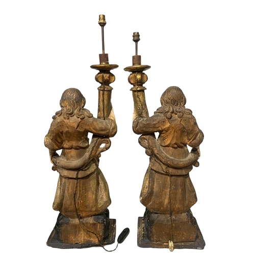 170 - A LARGE PAIR OF 17TH/18TH CENTURY ITALIAN CARVED GILTWOOD AND POLYCHROME STATUES
Depicting angels ho... 