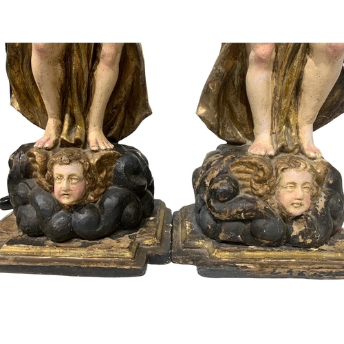 170 - A LARGE PAIR OF 17TH/18TH CENTURY ITALIAN CARVED GILTWOOD AND POLYCHROME STATUES
Depicting angels ho... 