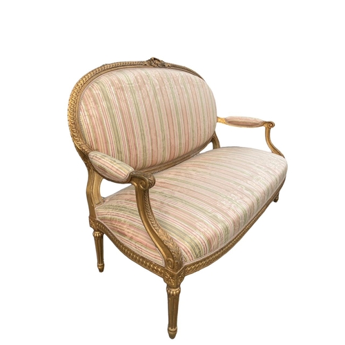 174 - AN 18TH/19TH CENTURY LOUIS XV DESIGN GILTWOOD SETTEE
The carved padded back above scrolling arms and... 