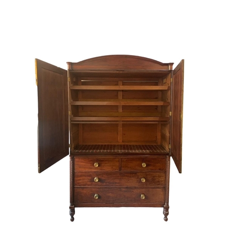 146 - IN THE MANNER OF GILLOWS, AN EARLY 19TH CENTURY REGENCY MAHOGANY LINEN PRESS
The arch pediment above... 