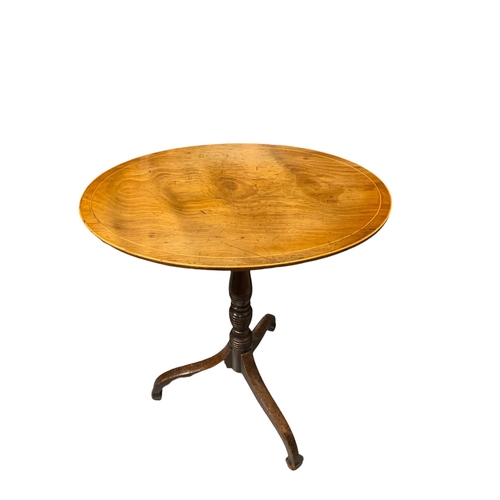 162 - A 19TH CENTURY REGENCY MAHOGANY OVAL OCCASIONAL TABLE
The inlaid top raised on a turned column termi... 