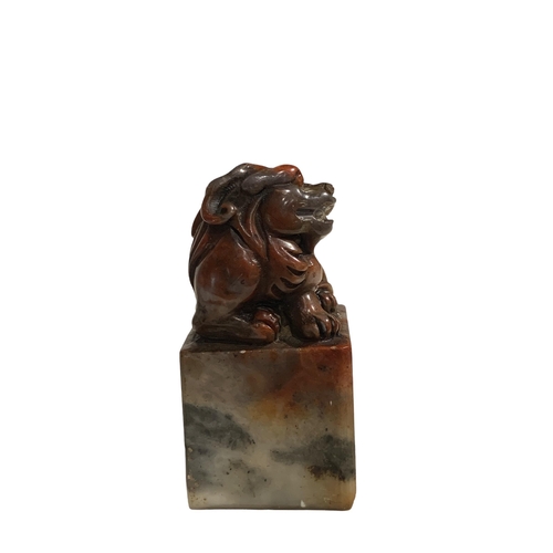 65 - A CHINESE JADE SEAL, surmounted by the figure of a lion dog, character seal to base. 
H- 6.9cm W-3.5... 