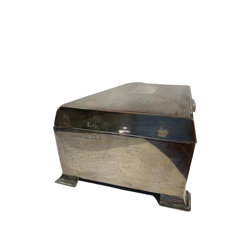 27 - W T TOGHILL & CO SILVER ENGINE TURNED CIGARETTE BOX
having cedar wood interior, raised upon stepped ... 