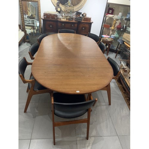 122 - A 20TH CENTURY DANISH DYRLUND TEAK EXTENDING DINING TABLE
Complete with two extra leaves and eight c... 