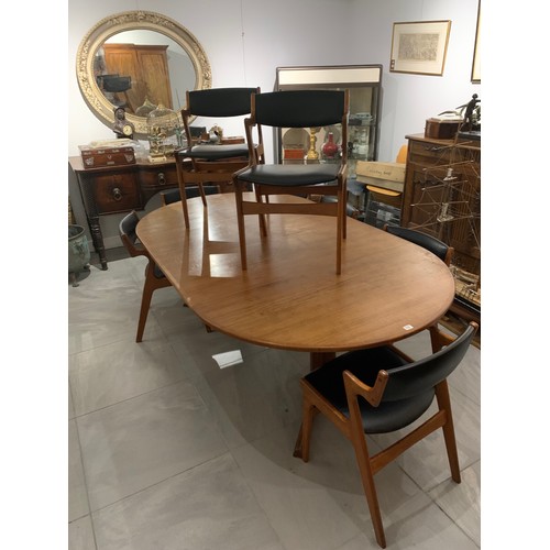 122 - A 20TH CENTURY DANISH DYRLUND TEAK EXTENDING DINING TABLE
Complete with two extra leaves and eight c... 