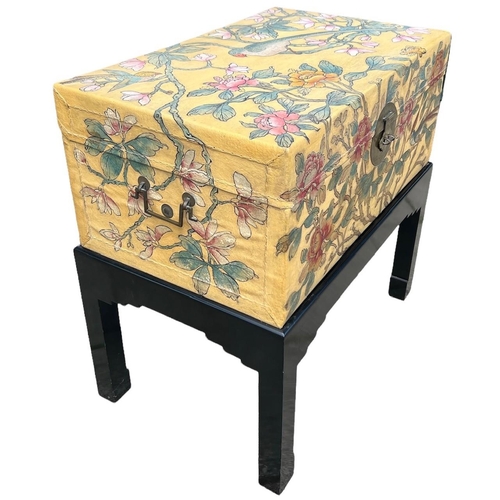 240 - A 20TH CENTURY JAPANESE PAINTED LEATHER CAMPHOR WOOD TRUNK ON EBONISED STAND
Decorated with a parrot... 