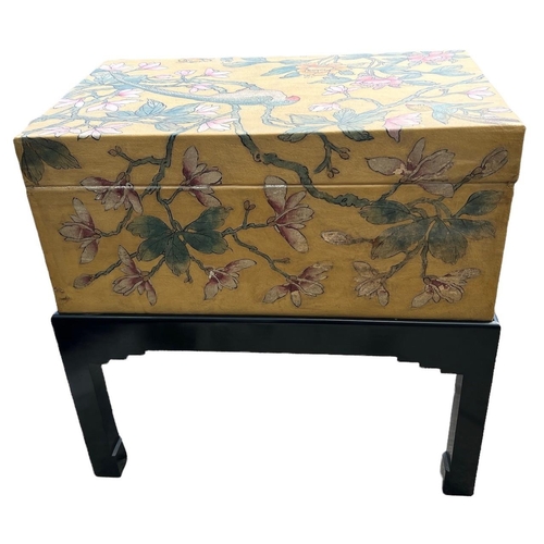 240 - A 20TH CENTURY JAPANESE PAINTED LEATHER CAMPHOR WOOD TRUNK ON EBONISED STAND
Decorated with a parrot... 