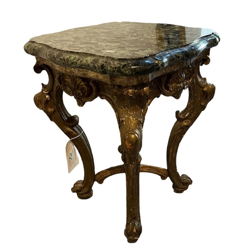 136 - AN EARLY 19TH CENTURY GILTWOOD OCCASIONAL TABLE
The later green marble top on cabriole legs with scr... 