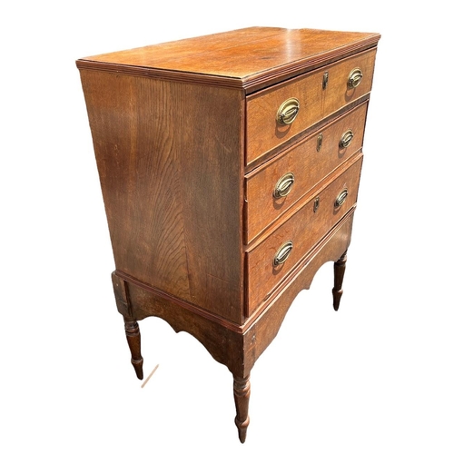 104 - AN 18TH CENTURY OAK CHEST ON STAND
With three drawers fitted with brass handles, raised on four turn... 