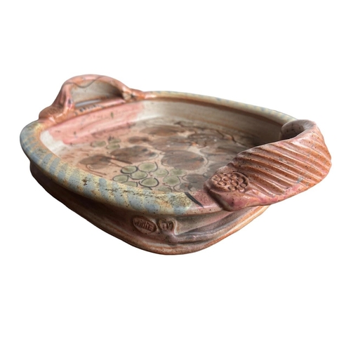 278 - WILLIE CARTER, B. 1952, A STUDIO POTTERY TWIN HANDLED TRAY
Decorated with grapes and vines, bearing ... 