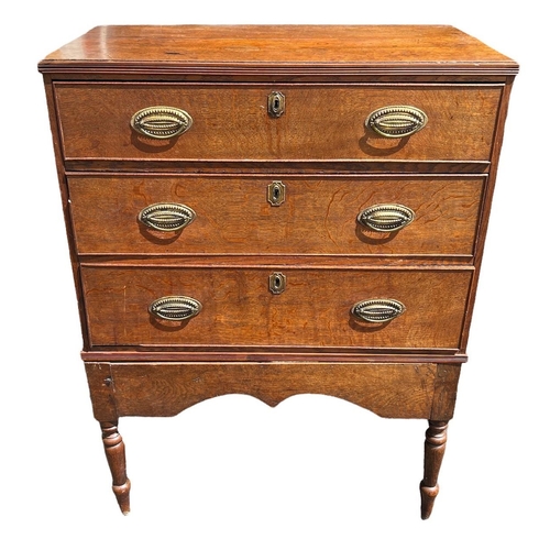 104 - AN 18TH CENTURY OAK CHEST ON STAND
With three drawers fitted with brass handles, raised on four turn... 