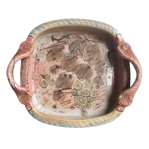 278 - WILLIE CARTER, B. 1952, A STUDIO POTTERY TWIN HANDLED TRAY
Decorated with grapes and vines, bearing ... 