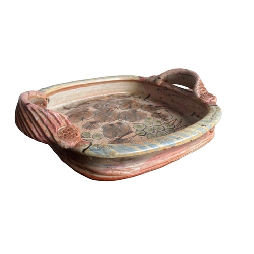 278 - WILLIE CARTER, B. 1952, A STUDIO POTTERY TWIN HANDLED TRAY
Decorated with grapes and vines, bearing ... 