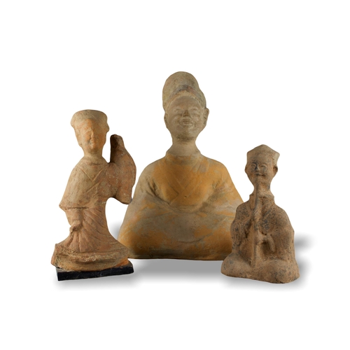 285 - THREE SICHUAN POTTERY FIGURES, HAN DYNASTY, BC 206 - AD 220
The unglazed redware figures individuall... 