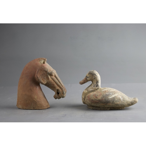 289 - A POTTERY HORSE'S HEAD AND A DUCK, HAN DYNASTY (BC 206 - AD 220)
The grey pottery applied with a red... 