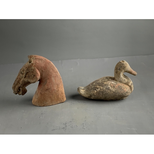 289 - A POTTERY HORSE'S HEAD AND A DUCK, HAN DYNASTY (BC 206 - AD 220)
The grey pottery applied with a red... 