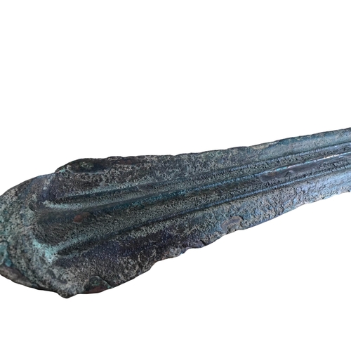 137 - A BRONZE AGE GREEK SHORT SWORD BLADE
Having three pronounced central ridges from chappe to point. 
(... 