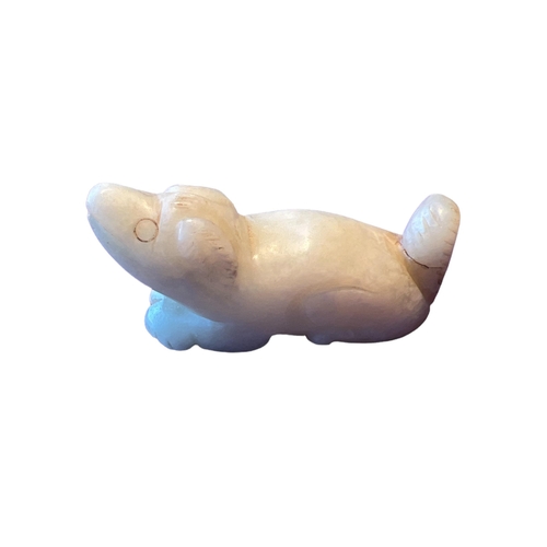 257 - A CHINESE QING DYNASTY (OR LATER) WHITE JADE CARVING OF A DOG
White ‘mutton fat’ colour, in a crouch... 