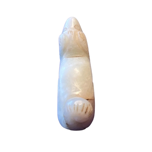 257 - A CHINESE QING DYNASTY (OR LATER) WHITE JADE CARVING OF A DOG
White ‘mutton fat’ colour, in a crouch... 