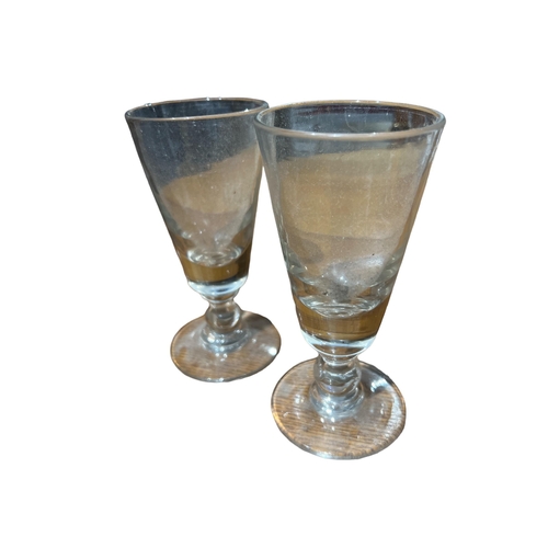 139 - A NEAR PAIR OF 18TH CENTURY GEORGIAN ALE GLASSES 
Both having cushion knops and snapped partial grou... 