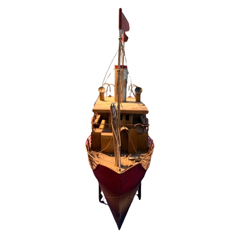 147 - A LATE 19TH/EARLY 20TH CENTURY TINPLATE BOAT RAISED ON STAND. 
(Height 37.5cm x Width 44cm x Depth 1... 