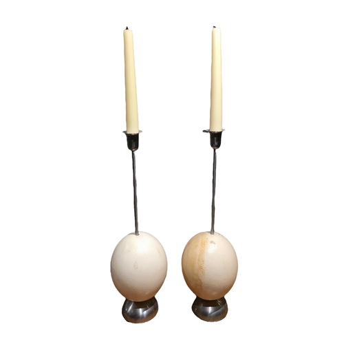 155 - A PAIR OF MID-CENTURY OSTRICH EGG SILVERED CANDLESTICKS (POSSIBLY ITALIAN).
(Height 39.1cm x Diamete... 