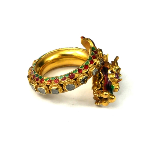 1 - A YELLOW METAL DIAMOND, RUBY AND ENAMEL DRAGON BYPASS RING
Dragon having ruby eyes with graduated fl... 