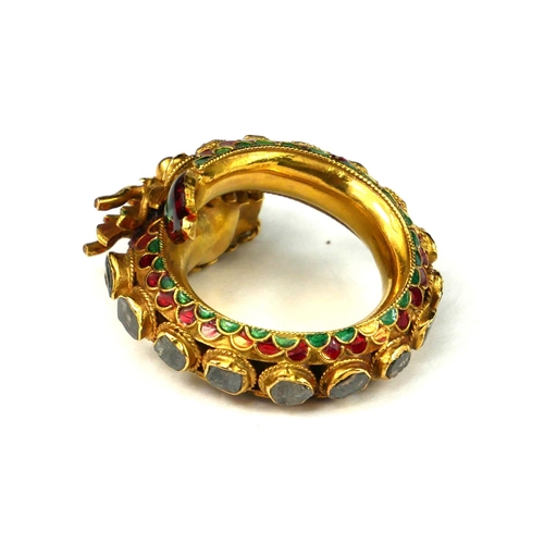 1 - A YELLOW METAL DIAMOND, RUBY AND ENAMEL DRAGON BYPASS RING
Dragon having ruby eyes with graduated fl... 