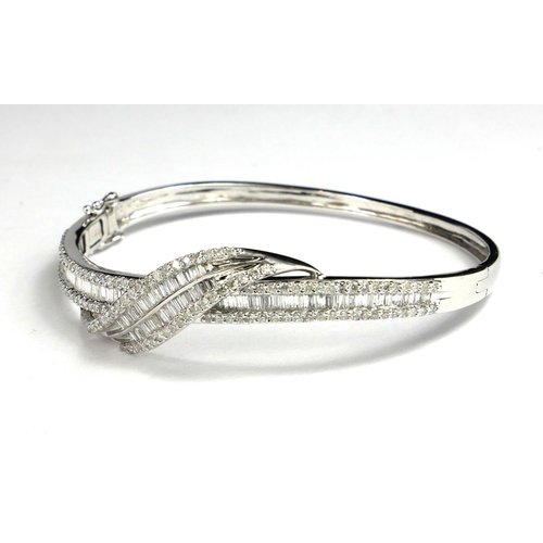 14 - AN 18CT WHITE GOLD BAGUETTE AND BRILLIANT CUT DIAMOND BANGLE
Boxed, with WGI certificate.
(total 2.7... 