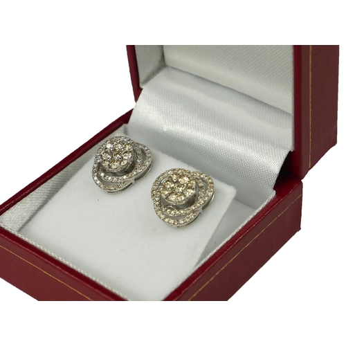 20 - A PAIR OF STYLISH SWIRLING 18CT WHITE GOLD AND DIAMOND CLUSTER STUD EARRINGS
Boxed. 
(diamonds 1.50c... 