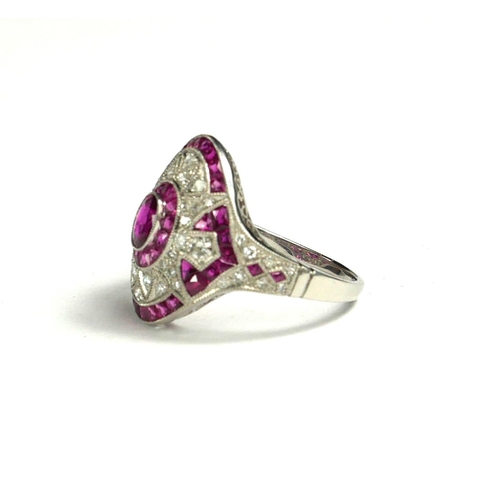 4 - A PLATINUM, RUBY AND DIAMOND FANCY ORNATE STYLE COCKTAIL RING
The oval ruby surrounded by a halo of ... 