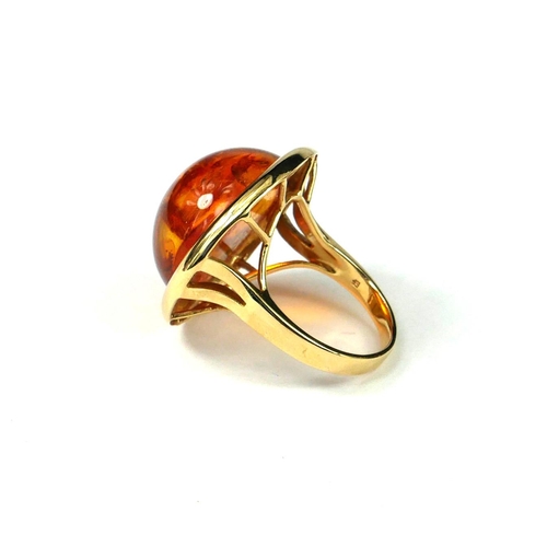 41 - A LARGE 14CT GOLD AND CABOCHON AMBER RING
Large central round Baltic amber approximately 20mm, havin... 