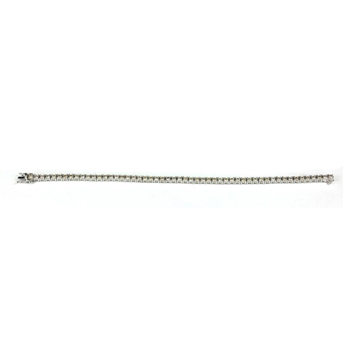 52 - A PLATINUM AND ROUND BRILLIANT CUT DIAMOND TENNIS BRACELET 
Boxed.
(diamonds 5.05ct)