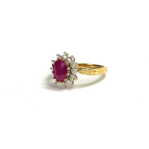 54 - A 9CT GOLD, OVAL CUT RUBY AND DIAMOND CLUSTER RING.
(ruby 1.72ct, diamonds 0.06ct)