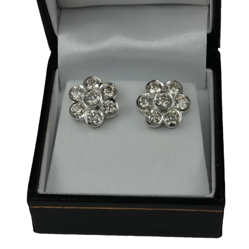 8 - A PAIR OF 18CT WHITE GOLD AND SEVEN STONE BRILLIANT CUT DIAMOND DAISY CLUSTER EAR STUDS
Boxed, with ... 