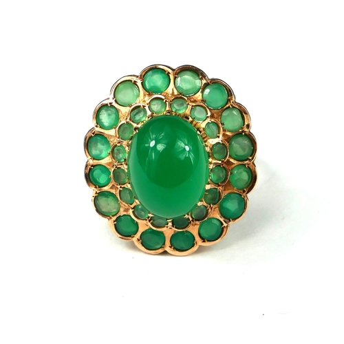 9 - A LARGE 14CT GOLD CABOCHON EMERALD COCKTAIL RING
Surrounded by a graduated emerald double halo setti... 