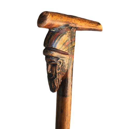 241 - A FOLK ART CARVED MAN WALKING STICK, TOGETHER WITH FOUR VARIOUS WALKINGSTICKS.