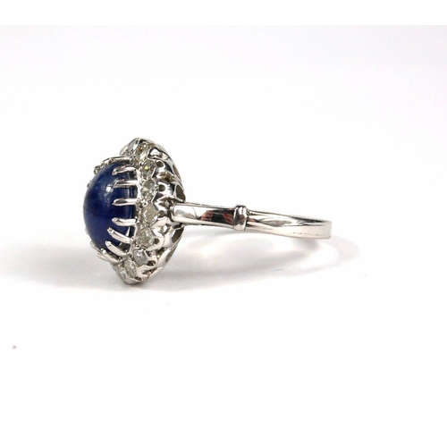 79A - A WHITE METAL RING WITH CABOCHON SAPPHIRE AND ROUND EIGHT CUT DIAMONDS.  (Sapphire approx. 2.00ct.  ... 