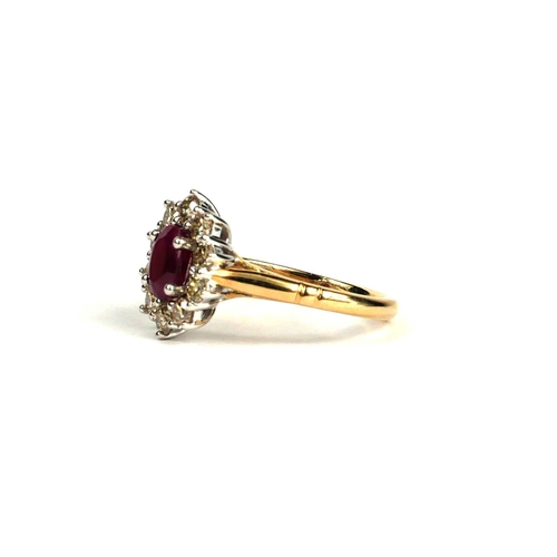 80A - A 9CT YELLOW AND WHITE GOLD OVAL RUBY AND DIAMOND CLUSTER RING .  (Ruby 0.80ct approx. Diamonds 0.87... 