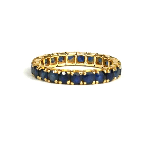 82A - A YELLOW METAL (TESTS AS 18CT GOLD) AND SAPPHIRE ETERNITY RING.
(UK ring size K½ , gross weight 1.9g... 