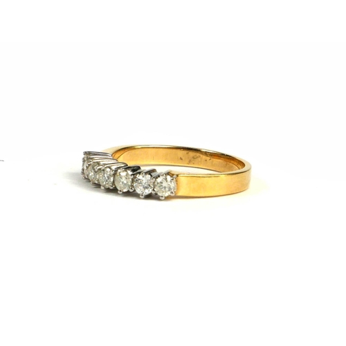 86A - AN 18CT YELLOW AND WHITE GOLD SEVEN STONE DIAMOND RING. (0.50ct)